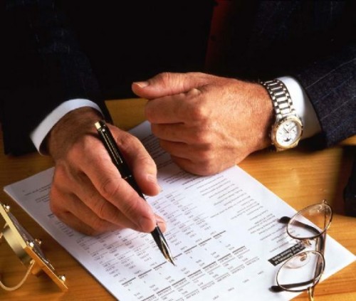 Lawyer reviewing an agreement of purchase and sale for a Toronto client.